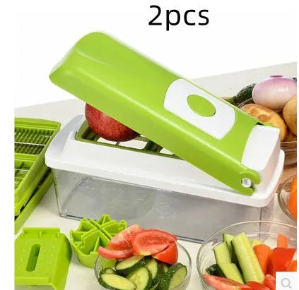 Green manual food chopper with stainless steel blades on a kitchen counter.