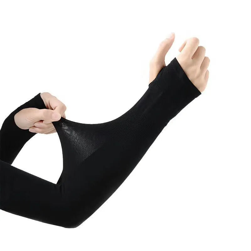 A person wearing a grey sun protection driving sleeve on their forearm, showing the open finger design.
