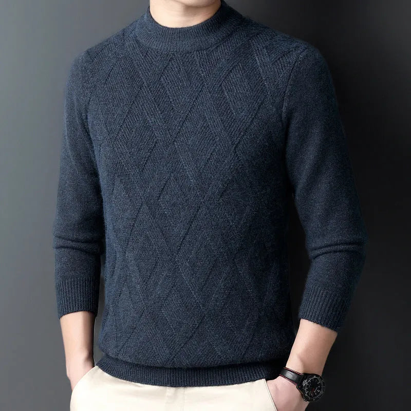 Man wearing a thick grey diamond jacquard knit pullover sweater.