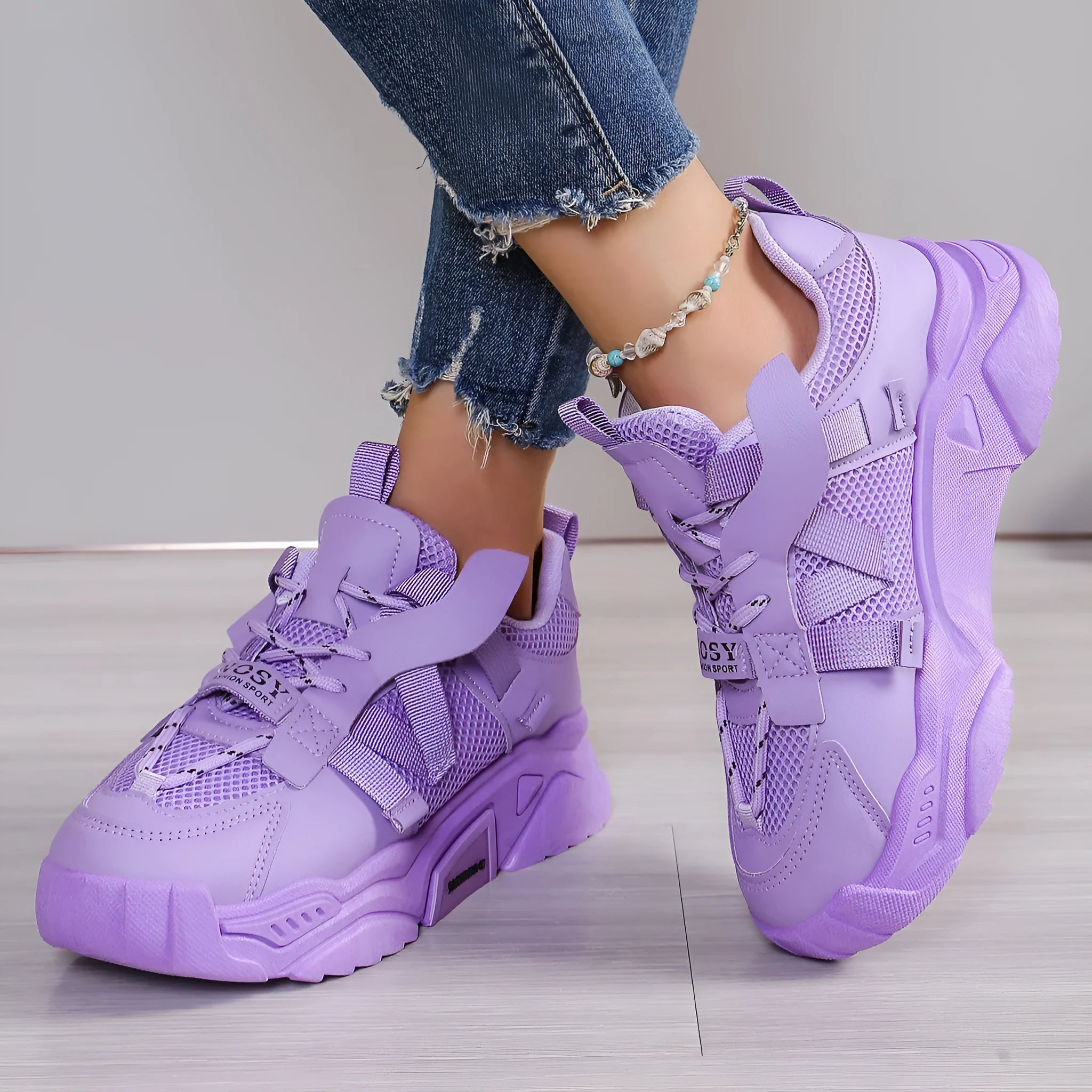 Women's purple platform sneaker with breathable mesh upper and lace-up front on a neutral background.