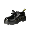 Women's black thick-soled lace-up shoes with ribbon and cross-strap design on a white background.