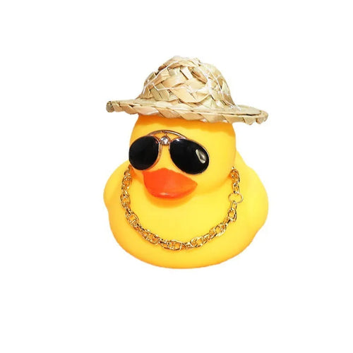 Yellow cartoon Straw Hat Duck car dashboard ornament with matte finish on a car interior.