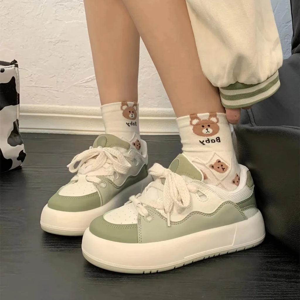 Green women's casual lace-up shoes with PU mesh upper and flat heel on a white background.