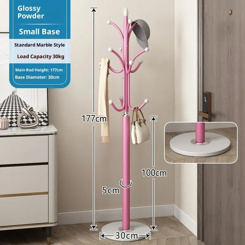 Floor-standing iron coat rack in black with vertical metal frame for hanging jackets and bags in a bedroom or hallway