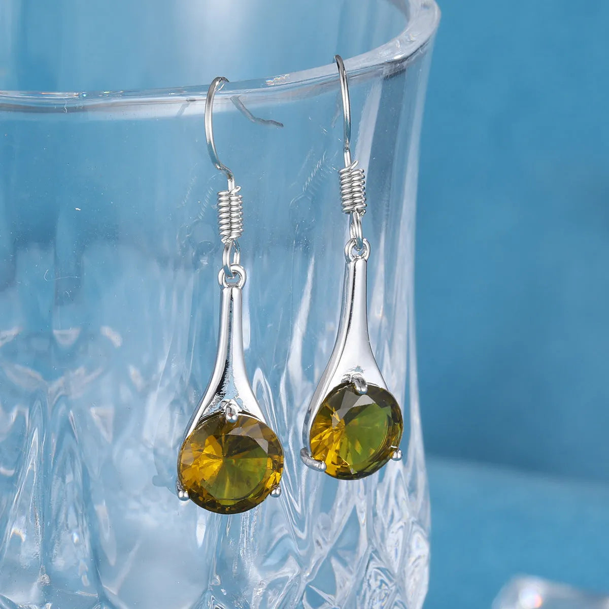 Olive green topaz drop earrings with water drop shape and retro styling