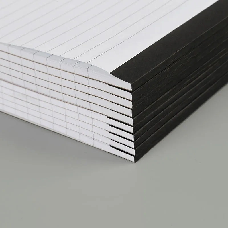 A4 tearable grid notebook with paper cover open to show ivory white pages with subtle grid pattern