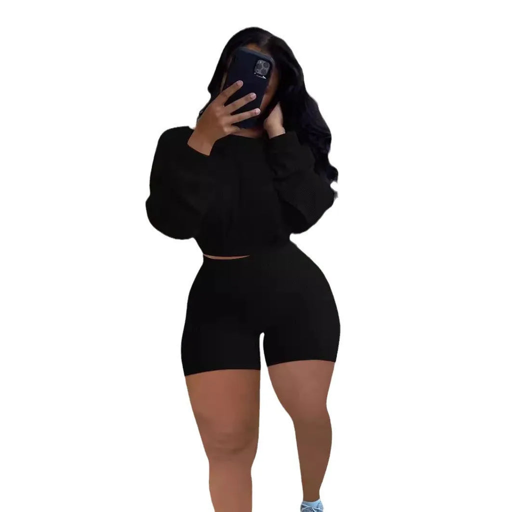 Sunken stripe solid colour off-the-shoulder long sleeve top and shorts two-piece set on a hanger.