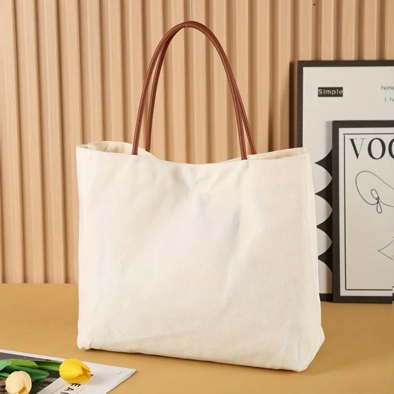 Large natural cotton canvas tote bag with wide straps, shown in beige white colour.