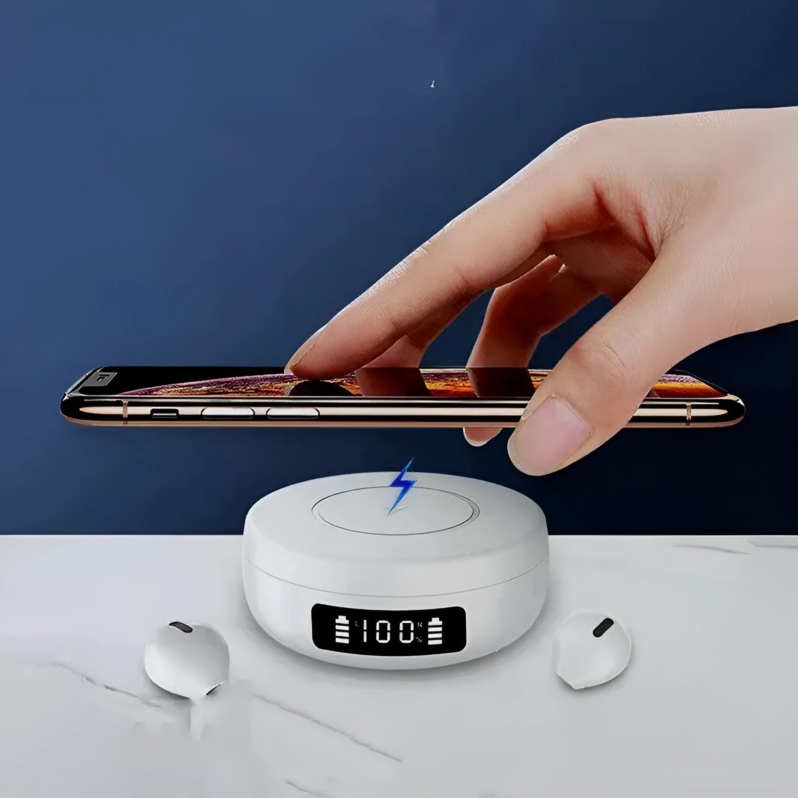Small black semi-in-ear wireless headphones with their wireless charging case on a table.