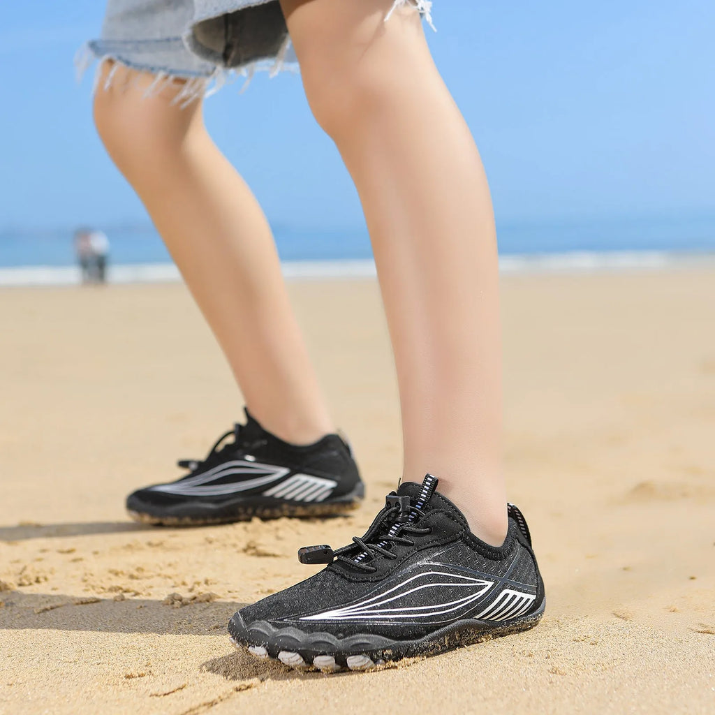 Children's black quick-drying water shoes with a non-slip rubber sole and elastic band.
