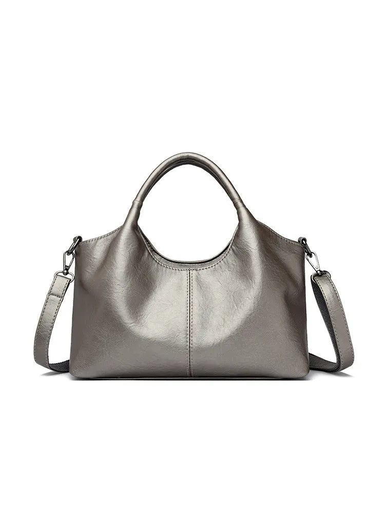 Women's genuine leather crossbody bag in beige colour showing soft construction and large capacity