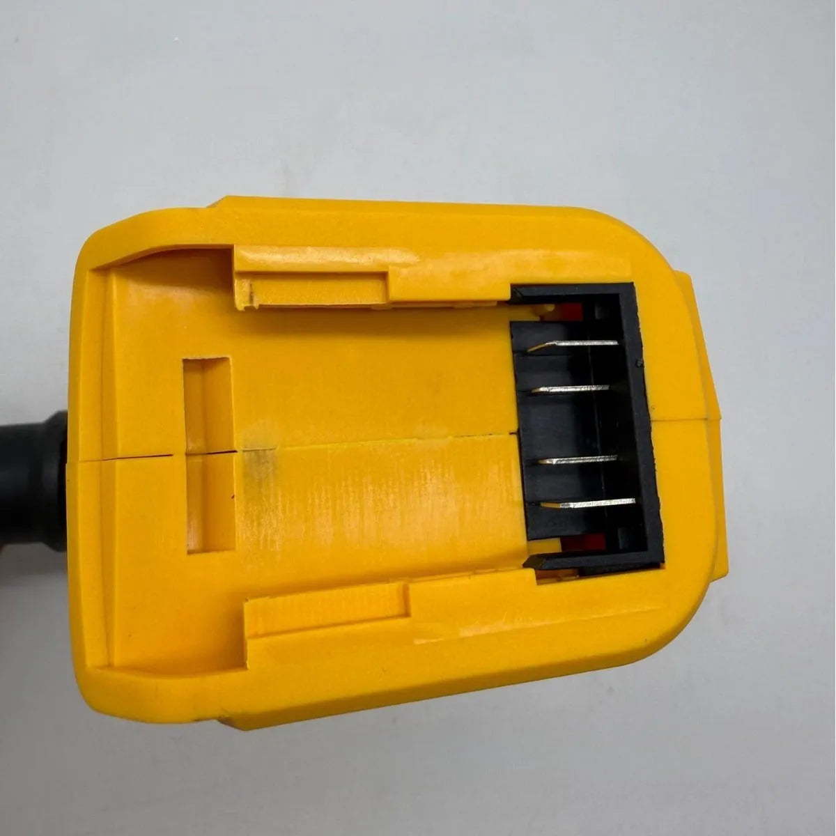 Handheld lithium battery snow blower and dust cleaner with bare metal head.