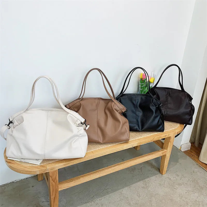 Large soft black PU messenger tote bag with car suture detailing and a long shoulder strap
