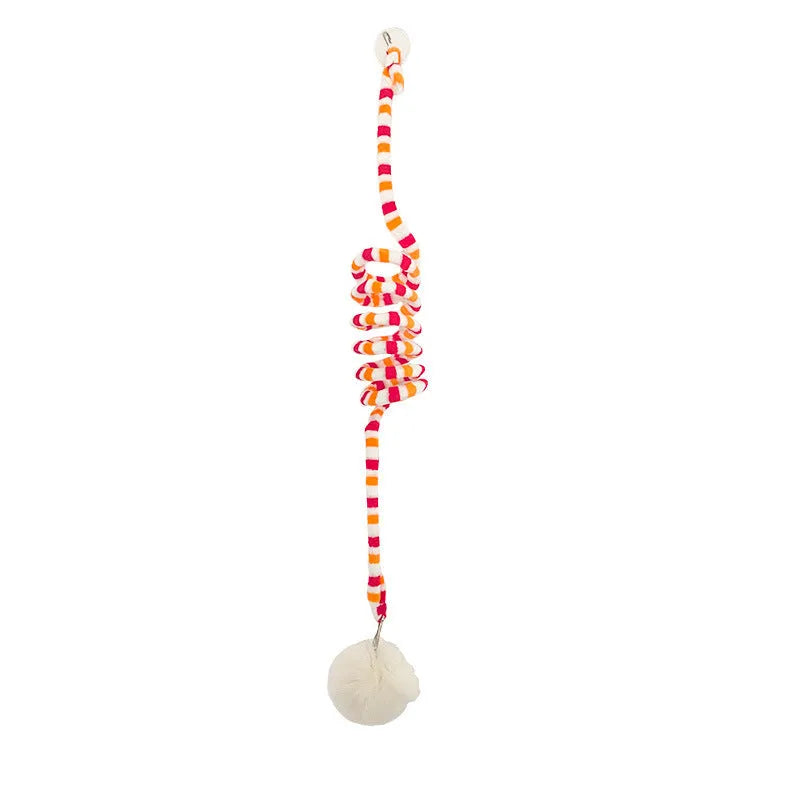 Hanging cat toy with bell stick and red inflatable ball attached to a glass door by a suction cup.