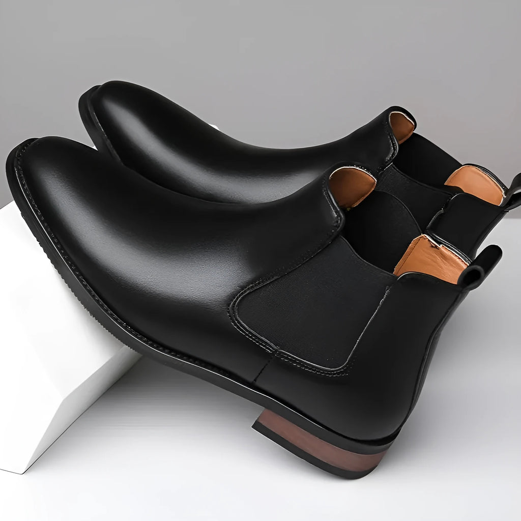 Men's black pointed toe Chelsea boots with artificial PU leather upper and decorative stitching