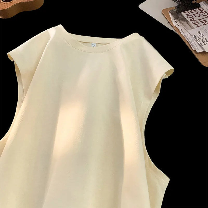Men's loose solid colour sleeveless cotton tank top on a hanger, shown in a light apricot shade.