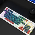 Luminous plastic computer keyboard in one of four colour combinations on a desktop.
