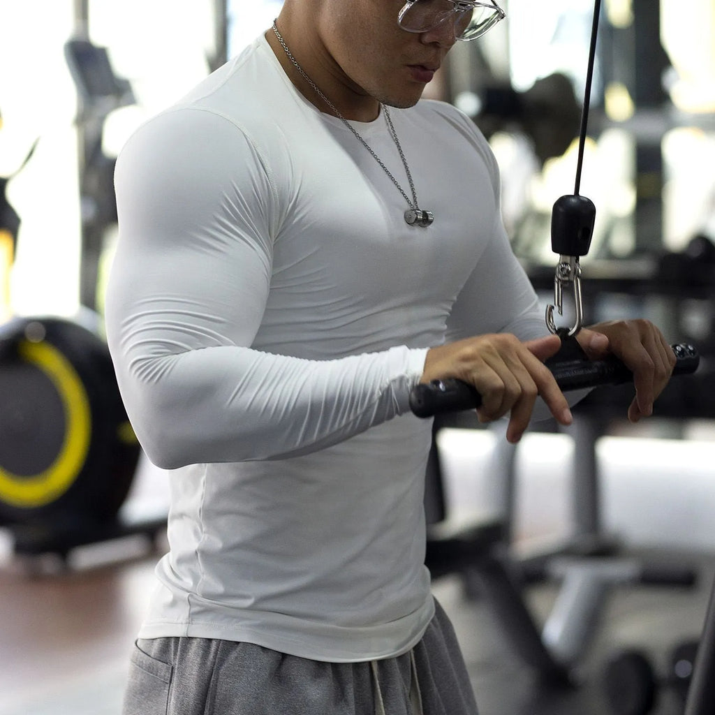 Men's slim fit black fitness tights with long sleeves for running and gym workouts.