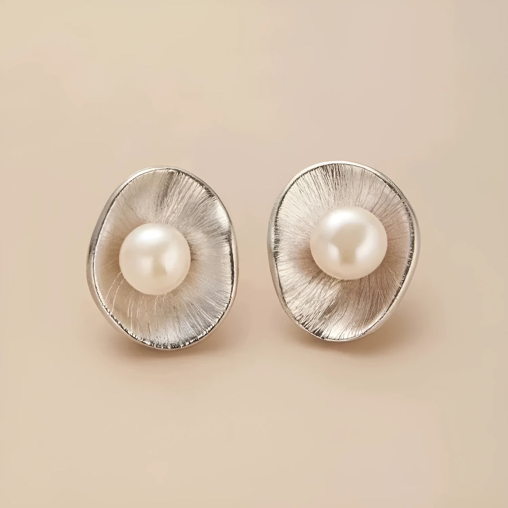 Pearl sterling silver needle earrings with geometric design and gold electroplated finish