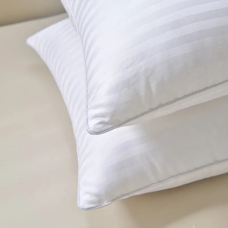 White cotton feather pillow with satin stripe detail, shown in low, medium, and high loft options.