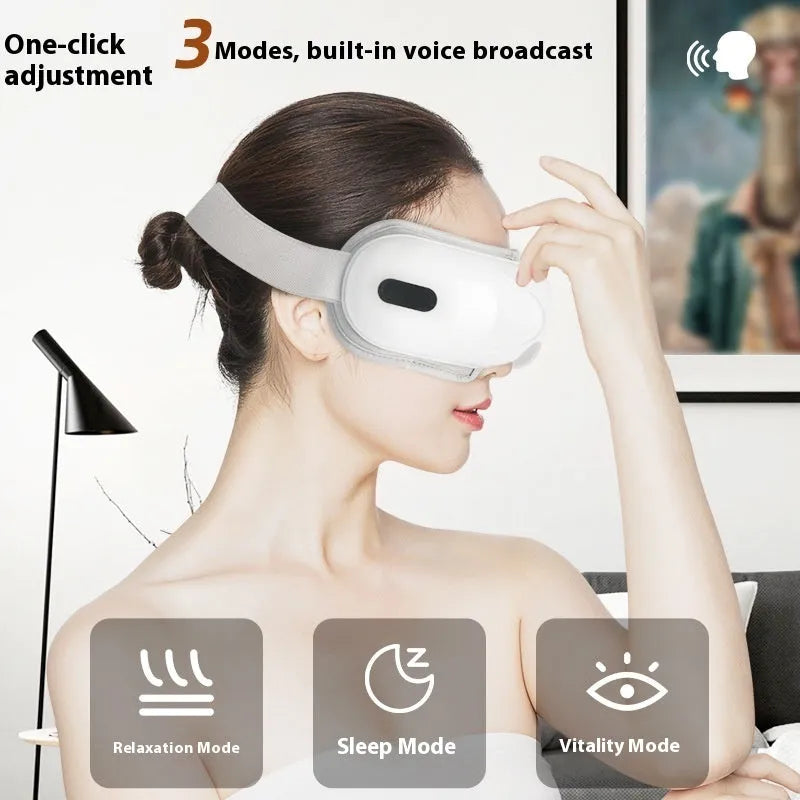 White rechargeable eye massager with heat and air compression therapy on a grey background.
