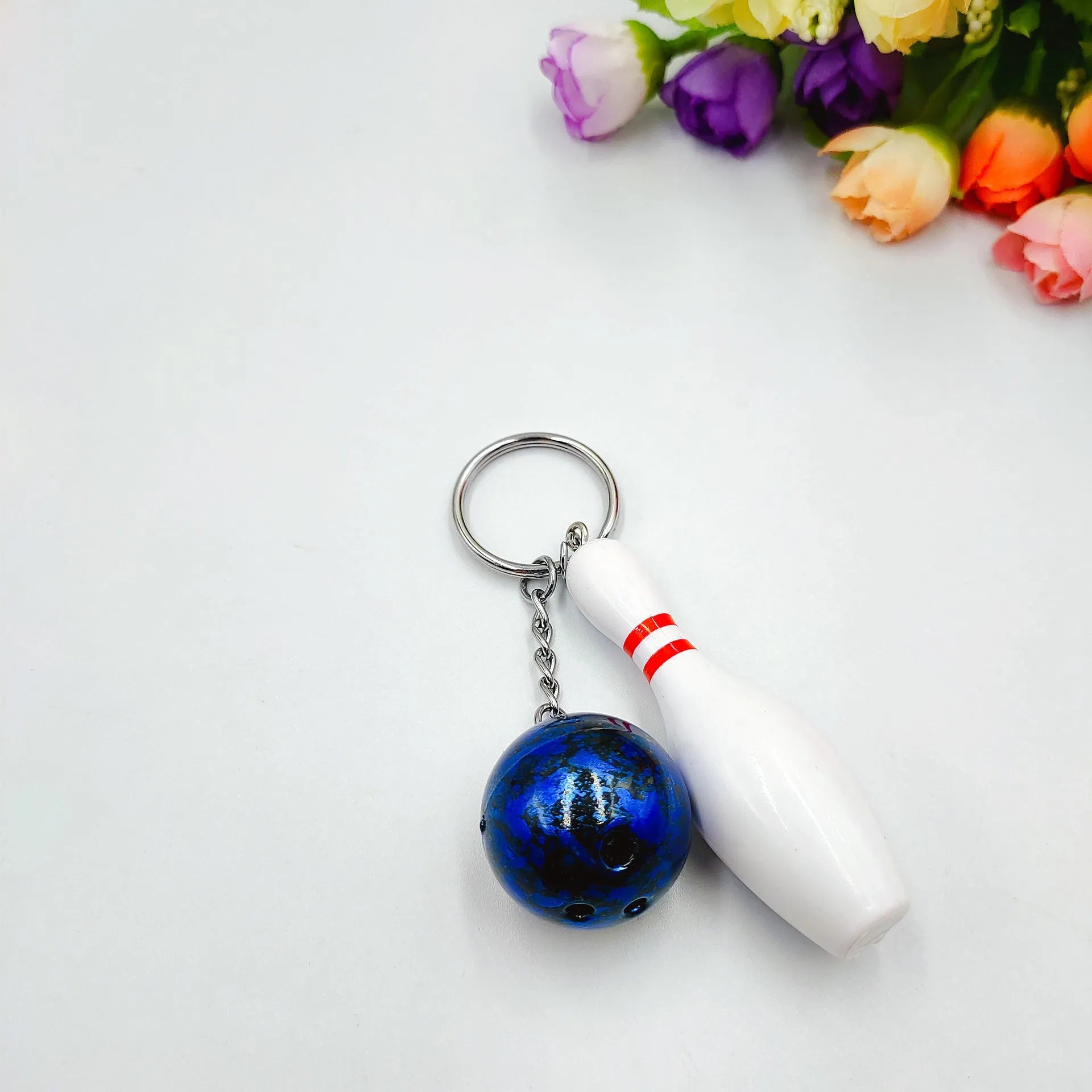 Mini simulation sports bowling pin keychain pendant in blue, dark red, green, or purple colour options.