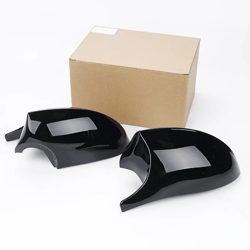 Pair of black ABS plastic rearview mirror housings for BMW 3 Series E90 on a white background.