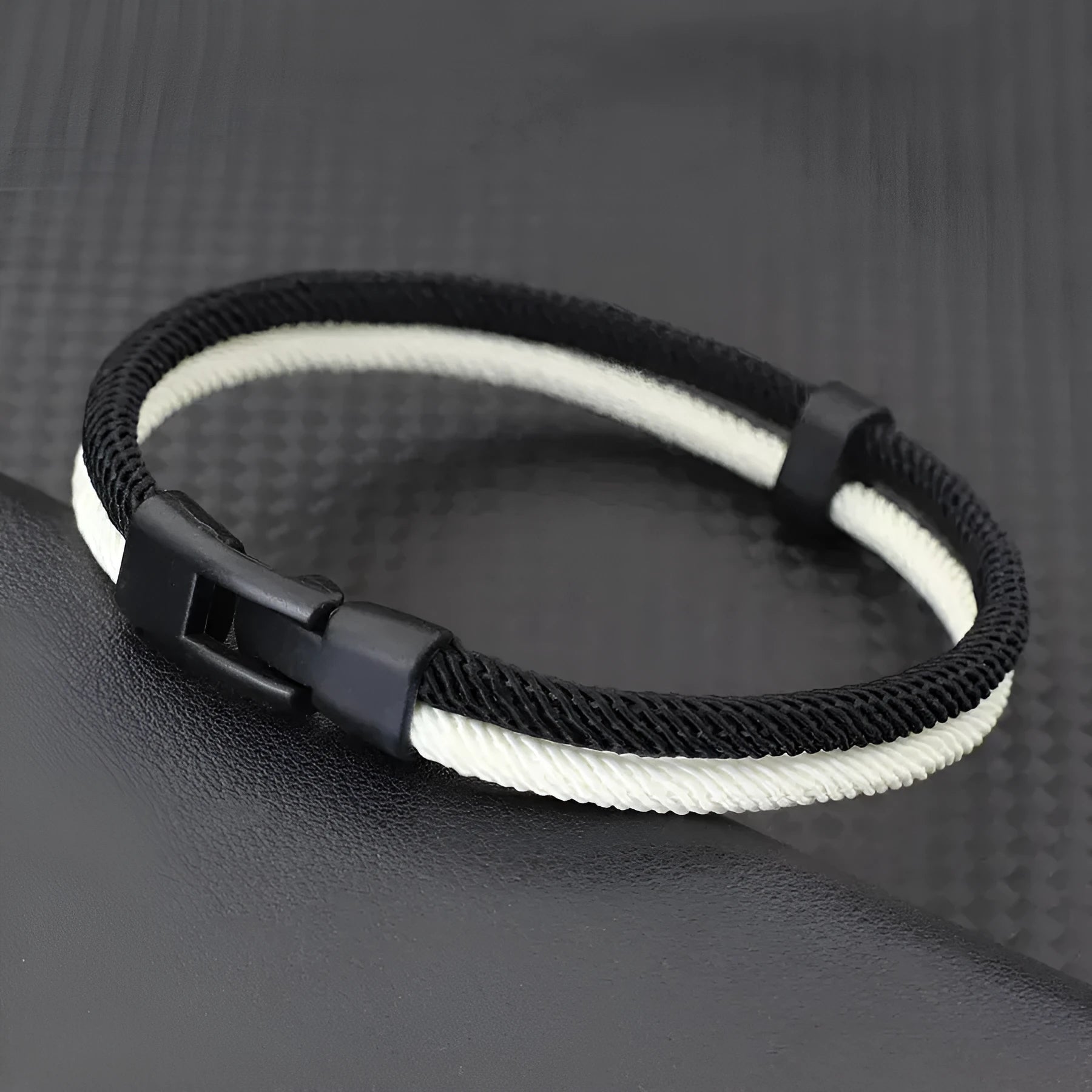 Black and white handmade woven hand strap with Milan rope alloy construction showing three size options