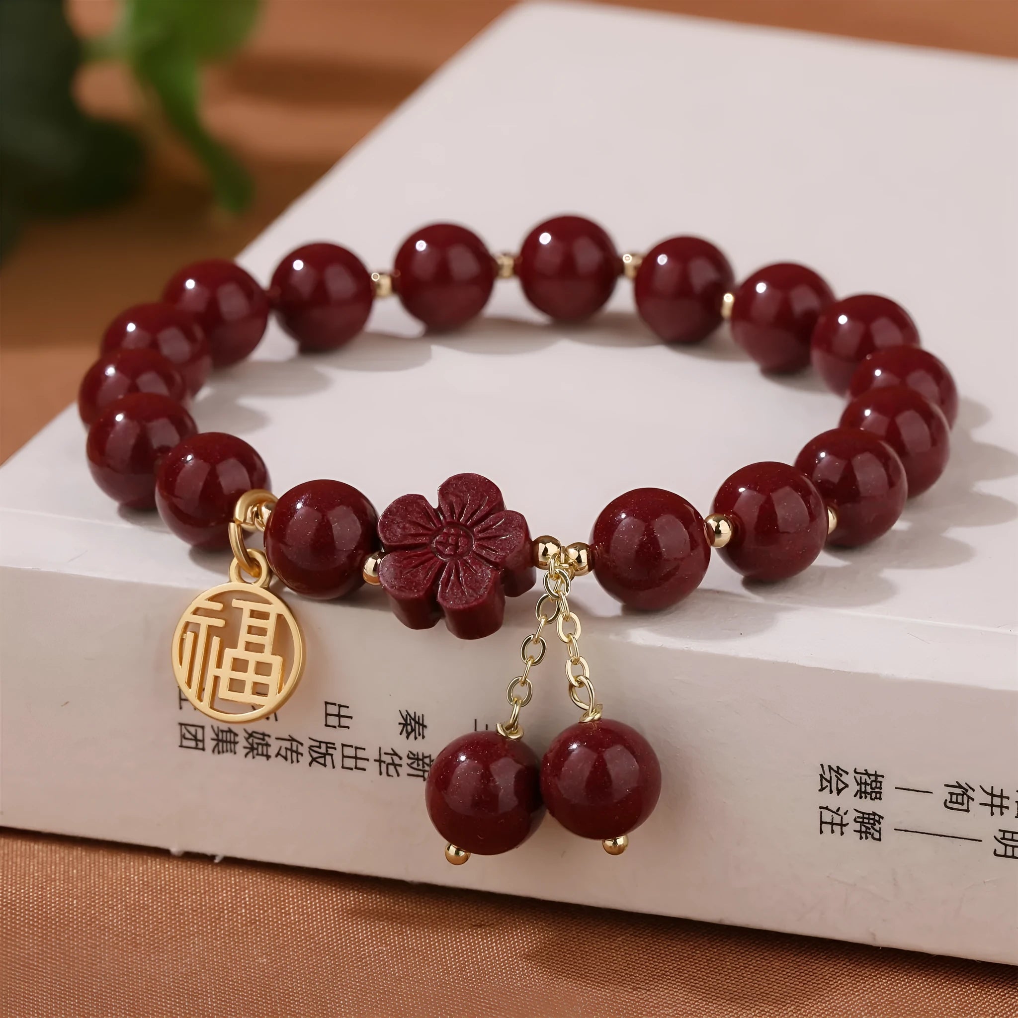 Women's national style cinnabar bracelet with fu character design and peach blossom tassel detailing
