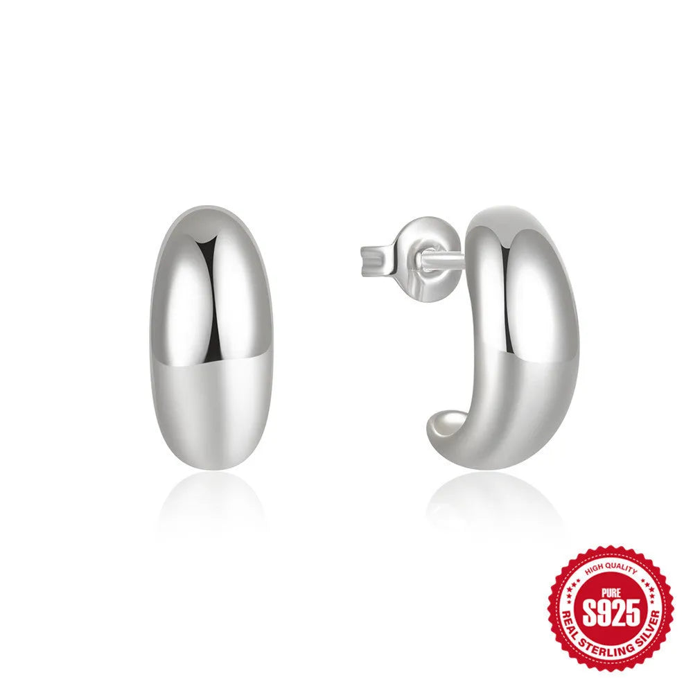 C-shaped sterling silver stud earrings with high polish gloss finish in gold colour