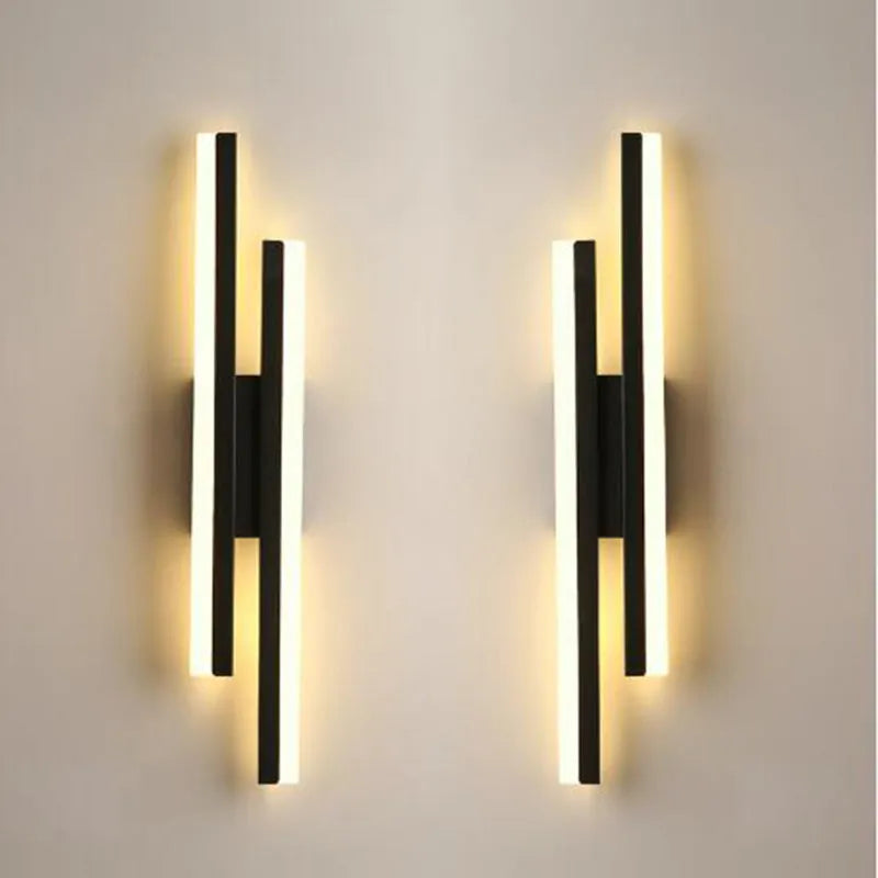 Modern Scandinavian minimalist LED wall light with acrylic shade in black or gold finish.