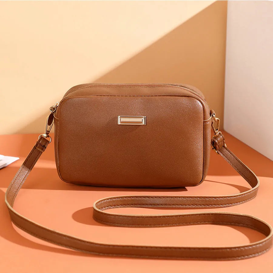Women's solid colour PU leather shoulder bag with three-dimensional pocket and square shape.